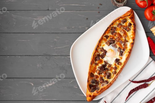 Preview: Turkish stuffed flatbread pide on gray wooden table