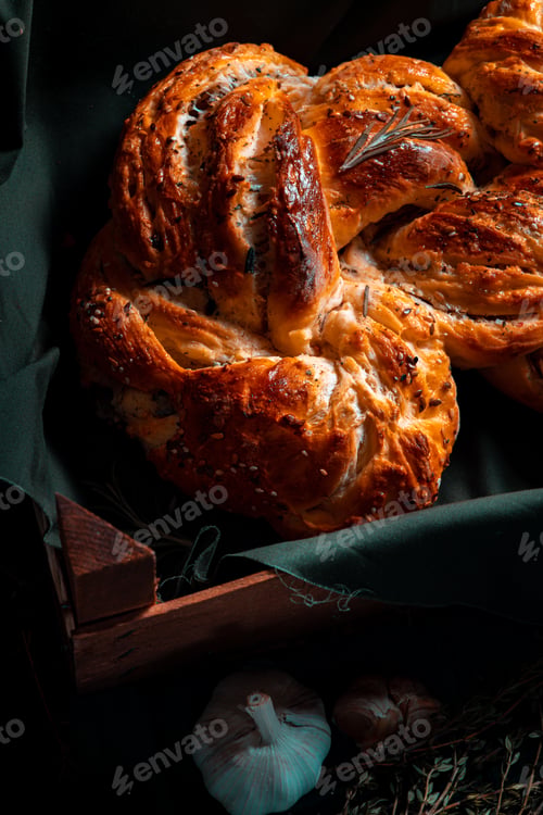 Preview: Freshly made Italian bread on greenwooden board with herbs and garlic, Mediterranean Food background