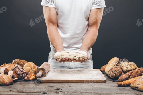 Preview: Baker with a variety of delicious freshly baked bread and pastry