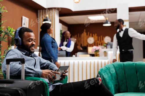 Preview: Happy guy hotel guest making video call