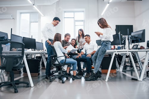 Preview: Group of young business people that standing and sitting and working in the office