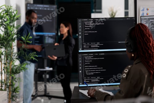 Preview: Multi ethnic team of software developers analyzing code