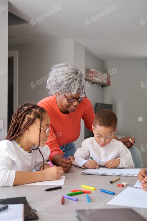 Preview: African mother painting with her children during the freetime.