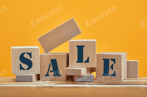 Preview: wooden blocks with the wordings SALE, isolated against yellow background.