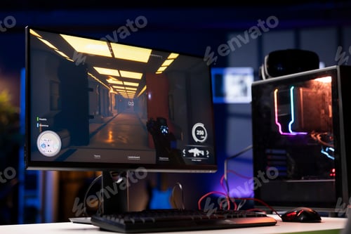 Preview: FPS videogame left open on PC screen in empty neon illuminated apartment