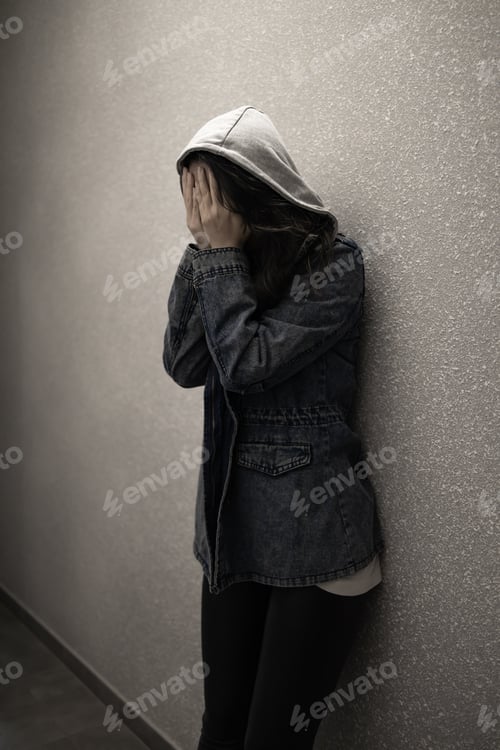 Preview: Silhouette of a depressed woman on the walkway of an apartment building. Sad woman, crying, drama, l