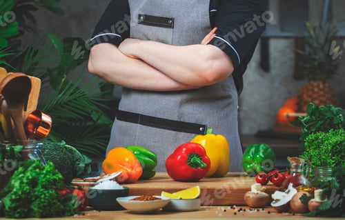 Preview: Chef confidently holds arms crossed over chest. Cooking food in the kitchen