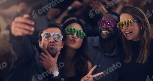 Preview: Cropped shot of a group of young friends taking selfies while dancing together in a nightclub
