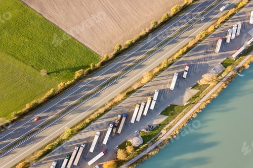 Preview: Top down aerial view of highway interstate road with fast moving traffic and parking lot with parked