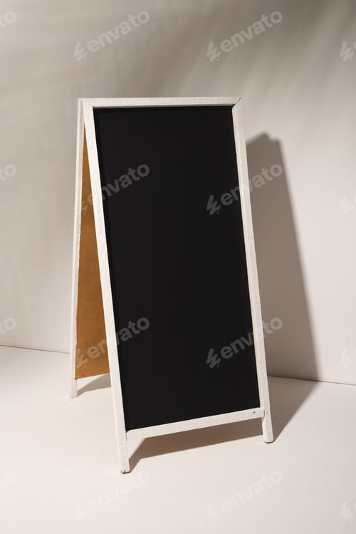 Preview: Black sign in white frame and copy space on grey background