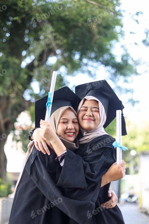 Preview: Happy high school Asian muslim girl embracing friend celebrate graduation