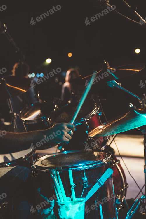 Preview: Musical group performing live outdoors.