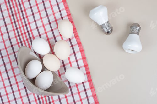 Preview: Several fresh chicken white eggs in gray plate on tablecloth