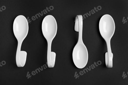 Preview: Ceramic serving spoons on black background, flat lay