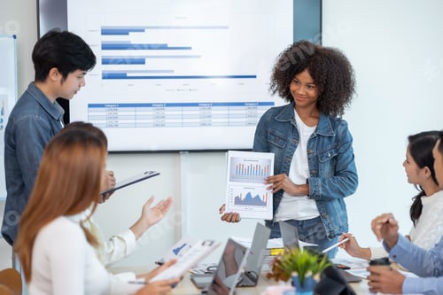 Preview: Beautiful Asian businesswoman presents her creative development planning strategy at a meeting