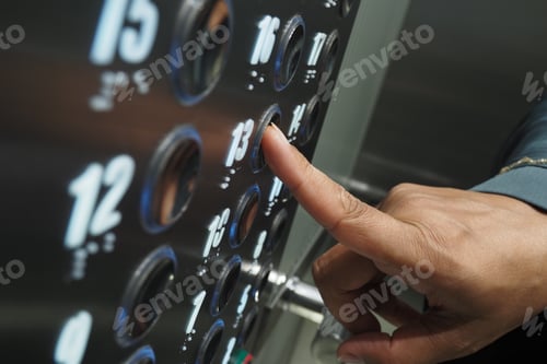 Preview: Close-up of a hand pressing elevator button on the floor panel