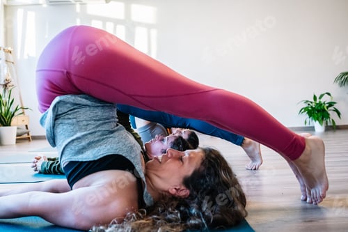 Preview: Woman doing exercise of flexibility during yoga class
