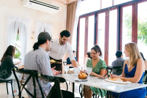 Preview: Waitress serving food to group of diverse customer in restaurant, eatery family client lifestyle