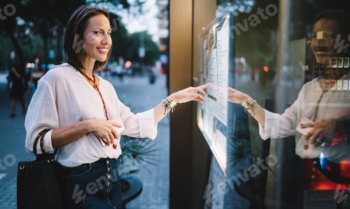 Preview: Happy female touching screen for self consulting at electronic system using advanced display
