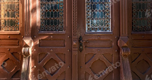 Preview: Old brown vintage doors with stained glass windows.