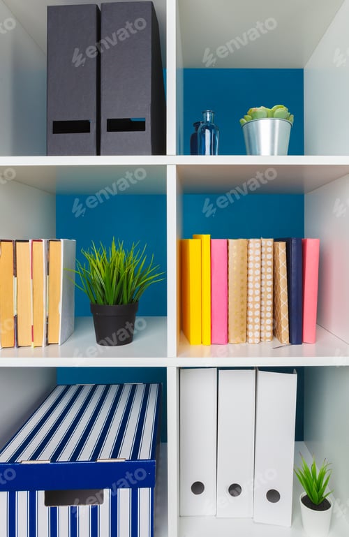 Preview: White office shelves with different stationery, close up