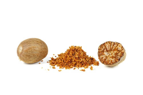 Preview: Grated half and whole nutmegs isolated on a white background closeup
