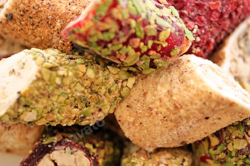 Preview: Rolls of turkish delight with many different flavors and fillings close up on table