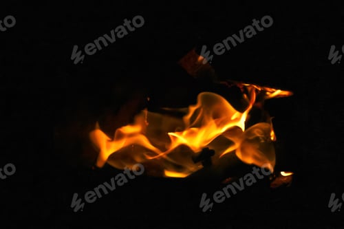 Preview: Orange flame fire on black background. Dramatic flames flickering against the darkness. Fire and hea