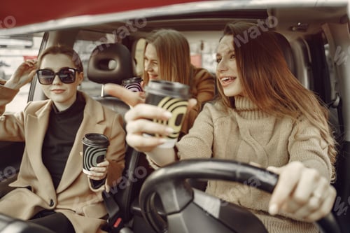 Preview: Three girls sitting inside the car and drinking a coffee