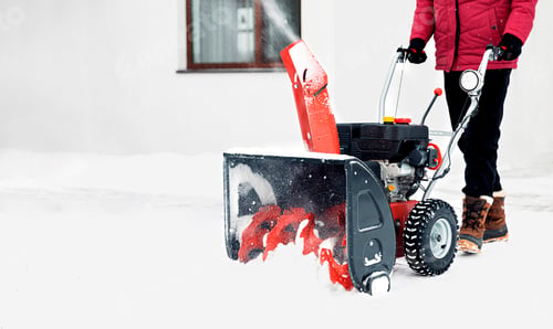 Preview: Man using red snowblower machine outdoor. Removing snow near house from yard