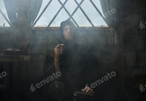 Preview: Mystery shot of clergyman holding rosary beads and bible praying surrounded mist
