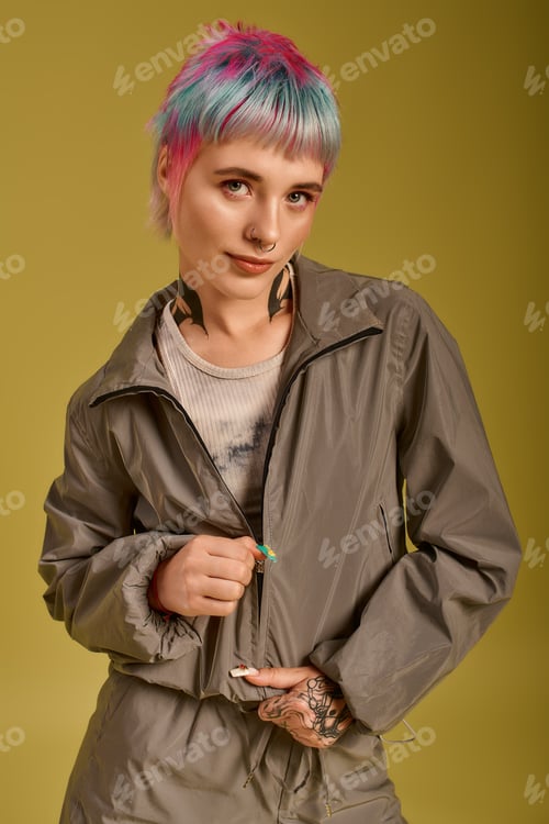 Preview: Colorful young woman embraces her unique style in a vibrant studio setting