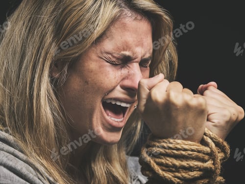Preview: Danger, scared and horror woman scream for help with hands tie with rope against black studio backg