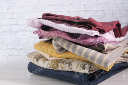 Preview: Close up of stack of cloths on table.