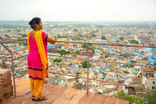 Preview: Portrait of Indian woman against view of Jodhpur the blue city in Rajasthan India