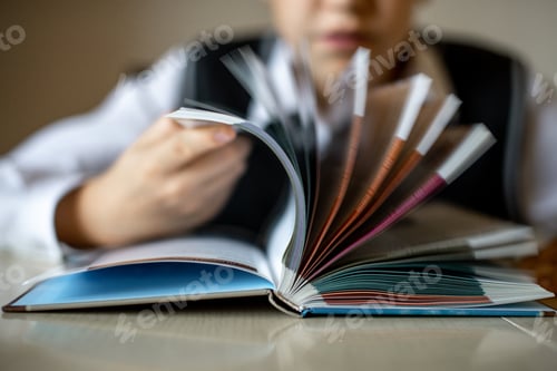 Preview: The boy is flipping through the book