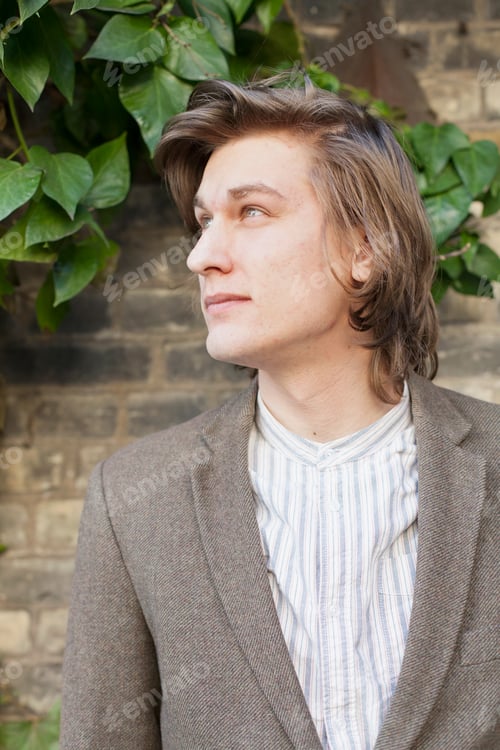 Preview: Thoughtful young man looking away outside restaurant