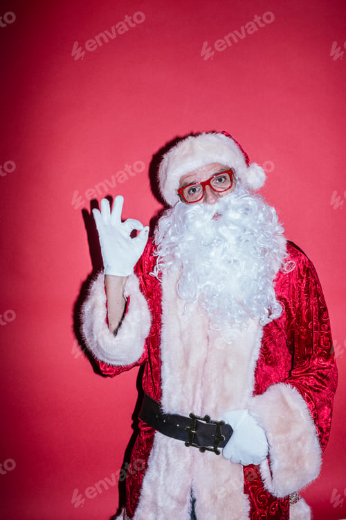 Preview: Man dressed as Santa Claus gesturing with funny glasses