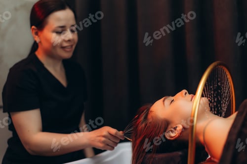 Preview: Woman enjoying scalp massage at head spa treatment