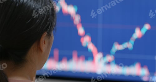 Preview: Woman watch on stock market data on computer
