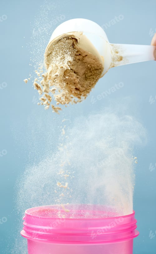Preview: protein powder spills in cup from measure scoop. whey sports nutrition. dry mixture