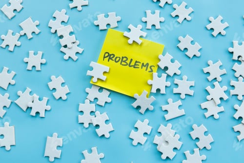Preview: Scattered Puzzle Pieces with Yellow Sticky Note Reading "Problems" on Blue Background