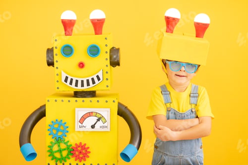 Preview: Happy child playing with robot