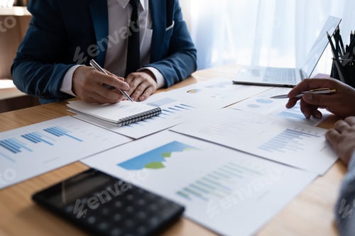 Preview: Young Asian businessman analyzing and discussing and brainstorming chart data. financial report grap