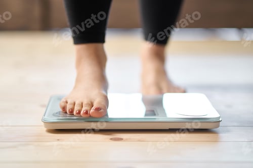 Preview: Feet of an Asian woman on a weight scale