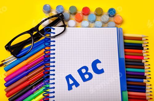 Preview: School supplies on yellow background. Flatly. Back to school concept
