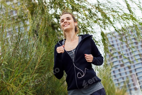 Preview: Young woman running in urban enviroment