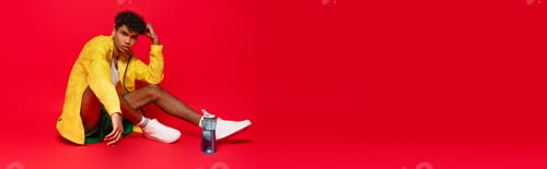 Preview: curly african american man in yellow rain jacket sitting near sports bottle on red, banner