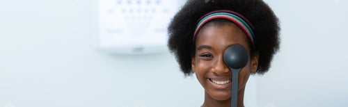 Preview: Young woman african american using occluder for eye test ophthalmological in optics clinic.