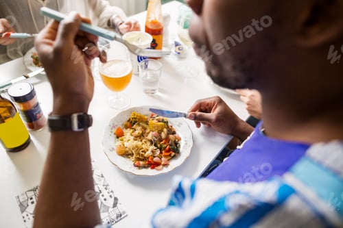 Preview: Cropped image of friends eating food at table